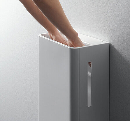 One person uses a TOTO hand dryer